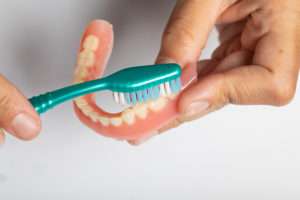 How do I care for my dentures?